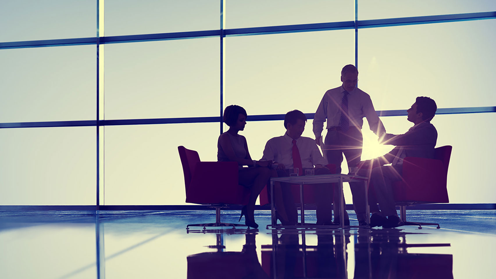 A group of colleagues meeting in an open meeting space