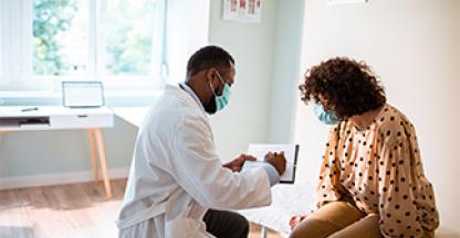 Woman at clinic getting checkup by doctor