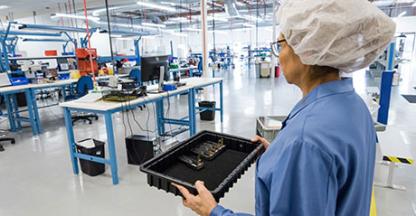 Woman carrying a tray in a lab