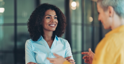 Business women smiling and talking with each other