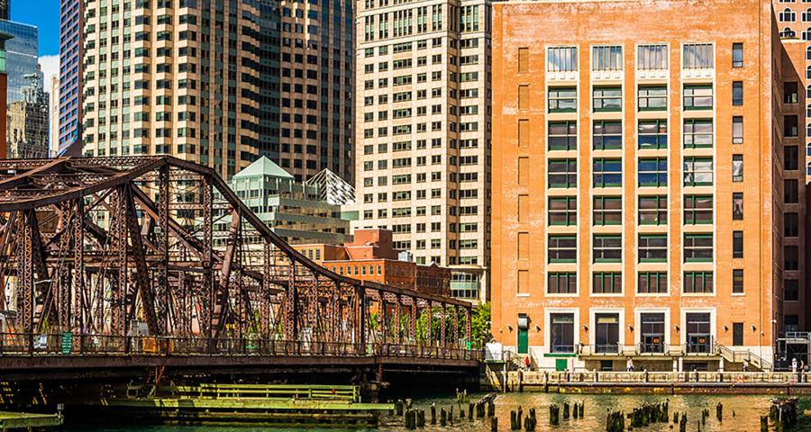 Riverside view of a bridge crossing a river in a city setting